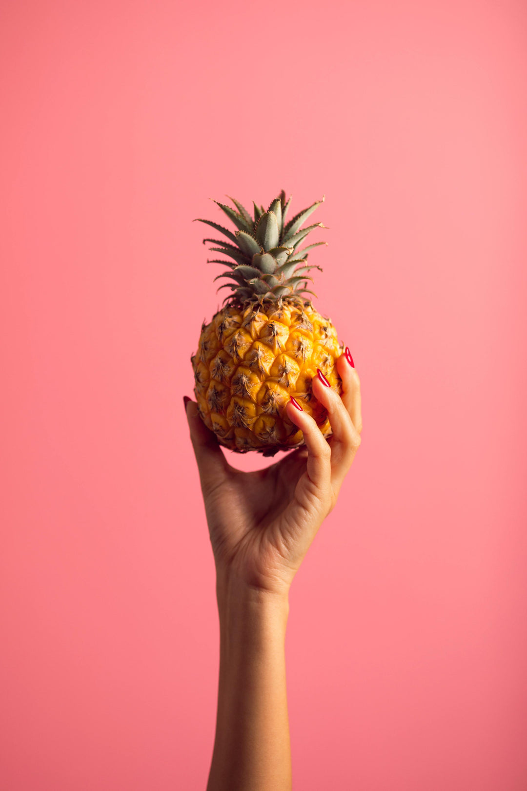 pineapple held in hand.